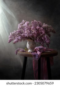 Still life with a bouquet of lilacs on a wooden table near the window. - Shutterstock ID 2305079659