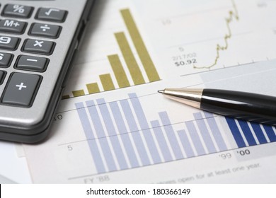 still life of budget stats and calculator  - Shutterstock ID 180366149