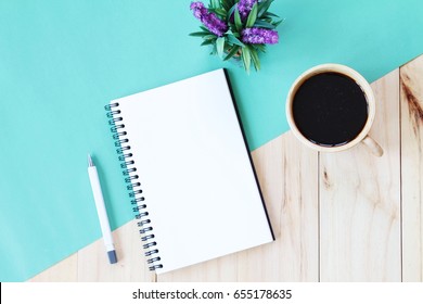 Still life, business, office supplies or education concept : Top view image of open notebook with blank pages and coffee cup on wooden background, ready for adding or mock up