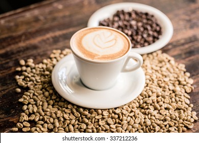 Still life of cappuccino cup and coffee beans