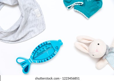 Still Life Of Children's Things. Plush Toy Gloves, Bath Thermometer, Socks, Bandana Drool Bib.