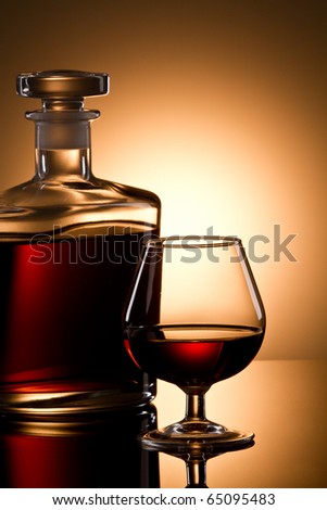 Still life with cognac glass and bottle