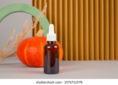 Still Life Composition With Dropper Bottle Of Natural Organic Cosmetics - Pumpkin Seed Oil Extract For Skincare Or Hair With Pumpkins And Plaster Models. Beauty Treatment, Natural Cosmetics Concept