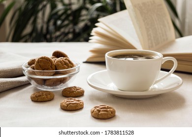 Still life with a Cup of coffee, cookies and a book. The atmosphere of a cozy morning Breakfast at home or in a cafe. - Powered by Shutterstock