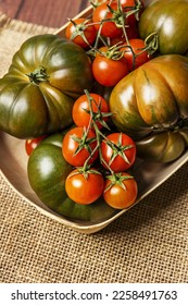 A still life of delicious ripe tomatoes on burlap cloth - Shutterstock ID 2258491763