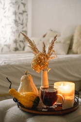 Still Life Details In Home Interior Of Living Room. Pumpkin And Cup Of Tea With Candles On A Serving Tray. Cozy Autumn 