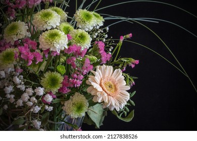 Still life of a flower bouquet in dark and moody tone with black background