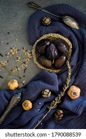 Still Life With Fresh Plums, Dried Herbs And Silver Spoon On Navy Blue Fabric. Top View Photo Of Different Objects. Colors Of August. 
