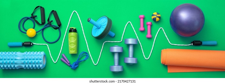 still life of group sports equipment for womens and cardiogram of jump rope, on green background. Fitness and healthy living, wellness concept. - Shutterstock ID 2170427131