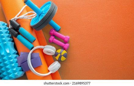 still life of group sports fit equipment for womens, on orange background. Fitness concept with empty space for text, top view - Shutterstock ID 2169895377