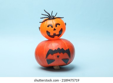 Still Life Of Halloween Decor On A Blue Background. Halloween Pumpkin And A Candy Bucket On Blue Background