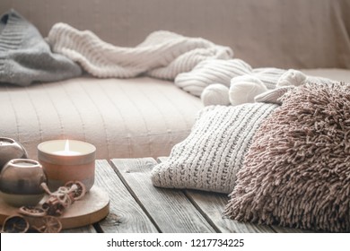 Still Life From Home Interior On A Wooden Background With A Candle And Pillows, Home Comfort Concept