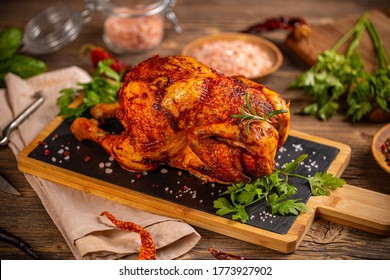 Still life of homemade chicken rotisserie on slate board