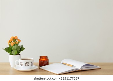 still life with house plant, notepad, pen and coffee cup in modern interior - Powered by Shutterstock