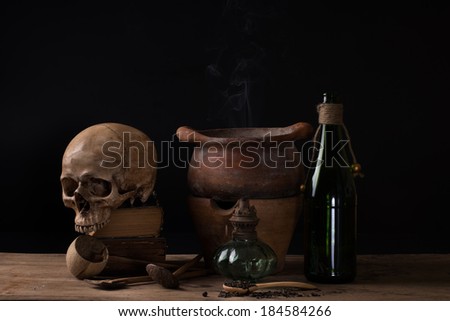Still life with human skull on old books and clay pots