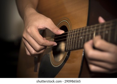 still life man playing guitar close up