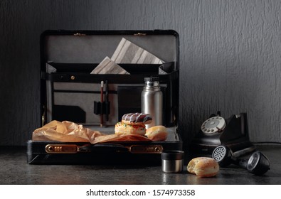 Still Life In Noir Style. Old Black Phone And Unfinished Lunch. Donuts And Thermos In Case.