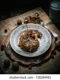 

Still Life With Oatmeal Cookies On A Round Metal Tray. Berries Of Mountain Ash In A Cup. Rustic Style. And Walnuts On A Plate. View From Above.