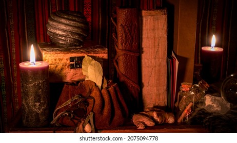 Still Life Of Old Books, Lit Candles And Other Witchcraft Equipment