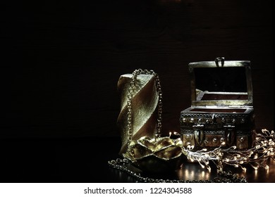 Still Life On A Long Exposure. Vintage Chest /jewelry Box Made By Hand In Morocco Surrounded By Candles And Lanterns.