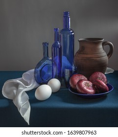 Still Life With Onions, Eggs, Jug, Blue Bottles And A White Napkin