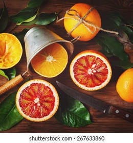 Still Life With Orange Fruit And Green Leaves On Wooden Table. Top View. Instagram Color Effect.