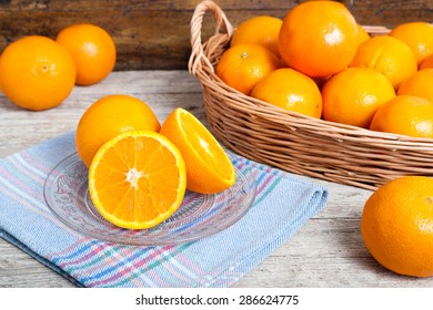 still life of oranges on wicker and wood background