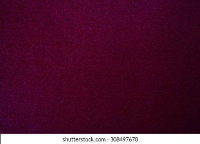 Still life paper texture background with a grain noise effect, full frame. Close up detail of a sheet of paper blank page with intense red dye on organic art paper. Background wall burgundy color.
