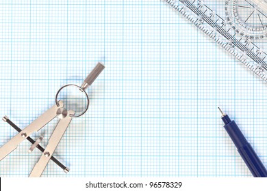 Still Life Photo Of Engineering Graph Paper With A Fine 0.1mm Pen, Compass And Protractor Ruler, Blank To Add Your Own Design, Image Or Text.