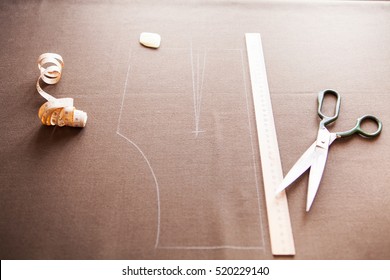 Still Life Photo Of A Suit Pattern Template With Tape Measure, Chalk And Scissors. Sewing And Tailoring Tools And Accesories.   