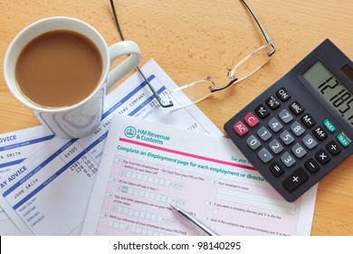 Still Life Photo Of A UK Employment Tax Return. The Payslip Is A Mock Up The Names And All Other Information On It Is Fictional.