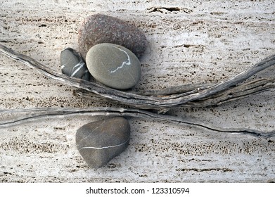 Still Life Photograph Of Weathered Sticks And River Stones.