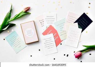 Still Life Photography Of Affirmation Cards And Tulips On A White Background