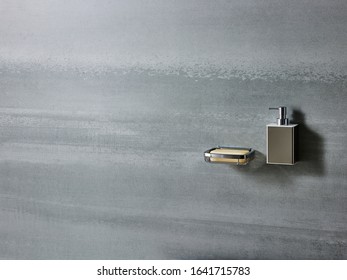 Still Life Photography Of Bathroom Hardware Fittings, Soap Dish And Soap Gel Dispenser Bottle On A Concrete Finish Wall