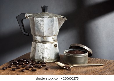 Still Life Photography, Old Stove Top Italian Espresso Maker With Coffee Bean, Coffee Grind And Spoon On Old Wood