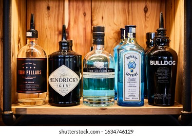 Still Life Photography Of Top Shelf Gin Bottles On A Timber Shelf Display In A Bar 