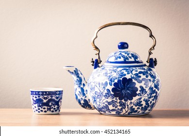 still life photography : traditional chinaware teapot and cup on wood table ( blue and white pottery )