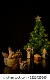 Still Life Of Pine Cones With Christmas Belen And Tree On Background