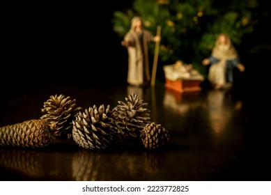 Still Life Of Pine Cones With Christmas Belen And Tree On Background