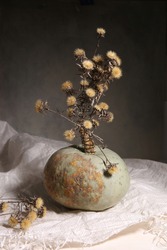 Still Life With Pumpkin And Dried Flowers. Dark Autumn Or Winter Composition With Pumpkin Indoor.