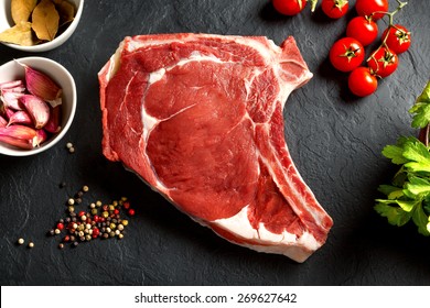 Still life raw thick rib over black background from above - Powered by Shutterstock