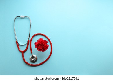 Still Life Red Stethoscope And Red Carnation On A Blue Background Symbolize The Day Of The Doctor