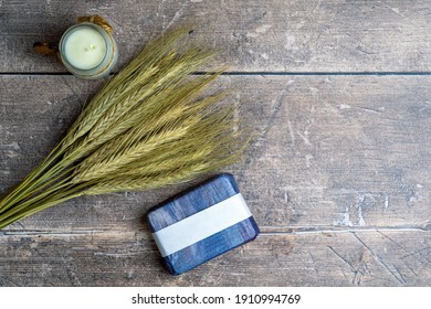Still Life Rustic Aromatherapy Flatlay Display Of Wheat Rye Bunch, Soap Bar , And Small Artisan Candle Life Style