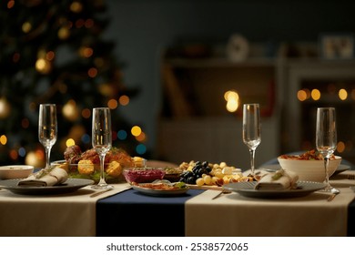 Still life shot of empty champagne flutes served with fruit and cheese platters on festive dinner table while Christmas lights glowing in blurred background, copy space - Powered by Shutterstock