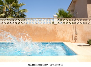 Still Life Of A Sunny Home Garden Swimming Pool With Water Splashing With Energy, No People, Outdoors Empty Space. Holiday Villa Pool Summer Holiday Break. Family Vacation Resort, Exterior.