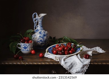 Still life with sweet cherries and vintage ceramic utensils