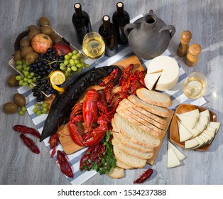 Still life with tasty  seafood, wine, cheese and bread on table