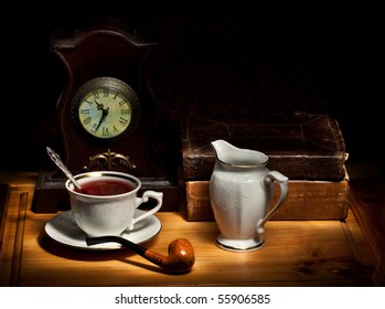 Still Life With Tea, Old Books, Milk Jug, Pipe And Clock