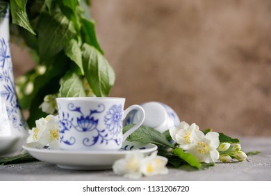 Still life with a tea set and jasmine flowers.