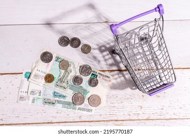 Still Life: There Is A Grocery Cart On The Table And Large Russian Money With Coins, The Concept Of The Rise In Price Of Goods